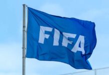 A blue flag with the FIFA logo waving in the wind