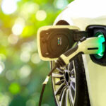 Electric car charging at a charging station.