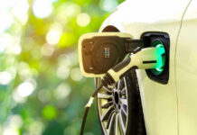 Electric car charging at a charging station.