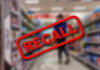 Gruesome Injury Triggers Amazon Recall Recall stamp on blurred store aisle background.