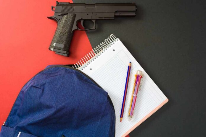 Handgun beside school supplies and a blue backpack