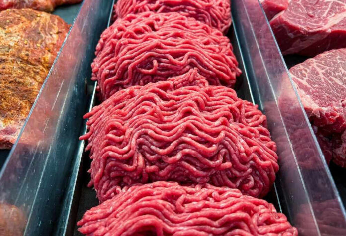 shutterstock_2235417437 Ground beef on display at a butcher shop.