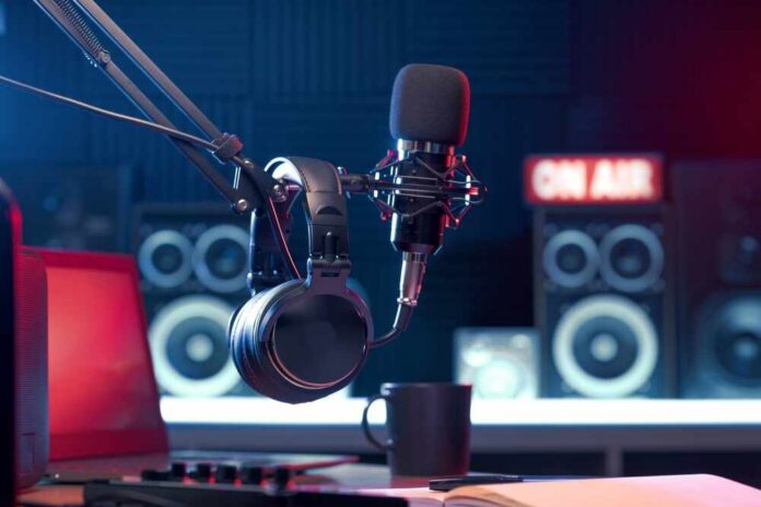 Close-up of a microphone and headphones in a podcast studio