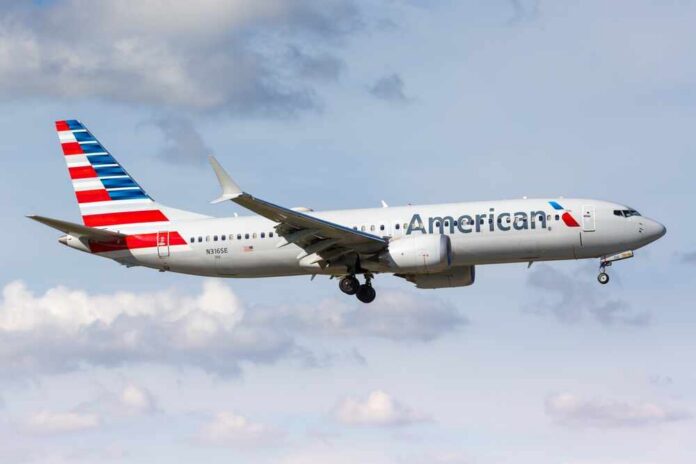 American Airlines airplane approaching for landing against a cloudy sky