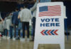 Trump Ally Surges — Enemies On Notice People in line next to Vote Here sign