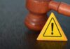 Slush Fund SHUT DOWN After Court Freeze Judge's gavel beside yellow warning triangle sign