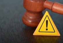 Name Grab Backfires — Judge Says Unlawful Judge's gavel beside yellow warning triangle sign