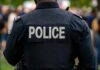Lib City Weekend Bloodbath Exposes Policy Failure Back view of a police officer wearing a uniform with 'POLICE' displayed