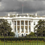 Explosive Drones Target Trump Event? The White House with dark clouds overhead.