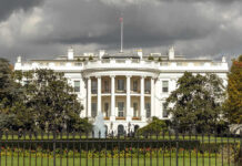 Explosive Drones Target Trump Event? The White House with dark clouds overhead.
