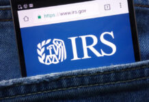 Smartphone showing IRS website in a denim pocket