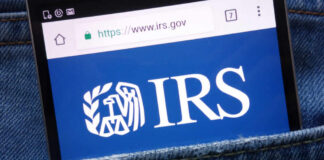 Smartphone showing IRS website in a denim pocket