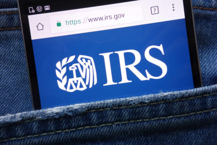 Konskie,,Poland,-,May,19,,2018:,Irs,(internal,Revenue,Service) Smartphone showing IRS website in a denim pocket