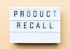 Lightbox sign with the words product recall on a beige background