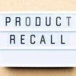 Lightbox sign with the words product recall on a beige background