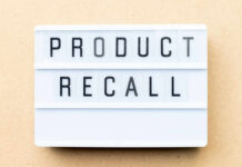 Lightbox sign with the words product recall on a beige background
