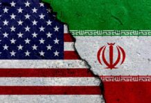 Iran Missiles Kill Americans — What Now? A cracked surface displaying the flags of the USA and Iran
