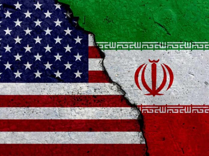 shutterstock_1607905798 A cracked surface displaying the flags of the USA and Iran