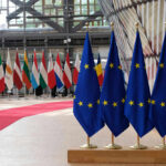 EU flags and European flags on the background.
