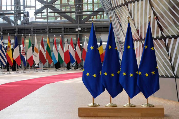 shutterstock_1825608365 EU flags and European flags on the background.