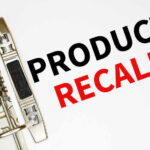 Recall Panic: Batteries Ignite Mid-Charge A binder clip holding a sheet of paper with the words 'PRODUCT RECALL' printed in bold letters
