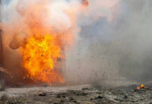 Holiday Blast Turns Deadly A large explosion with flames and smoke.