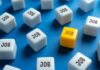 Record NILF Shocker: What’s Really Going On? A yellow cube with the word 'JOB' surrounded by white cubes with the same word on a blue background