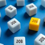 Record NILF Shocker: What’s Really Going On? A yellow cube with the word 'JOB' surrounded by white cubes with the same word on a blue background