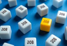 Record NILF Shocker: What’s Really Going On? A yellow cube with the word 'JOB' surrounded by white cubes with the same word on a blue background