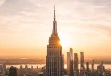 Empire State SHOCKER: Spire Breach Sparks Felonies New York City skyline at dusk with skyscrapers.