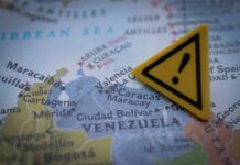 50,000 Missing: Venezuela’s Shocking Numbers A close-up of a map showing Venezuela with a yellow warning sign