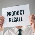 ALERT: Glass In Dinner Rolls! Person holding a sign reading product recall
