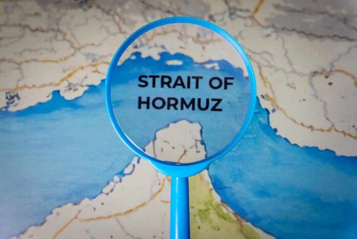 A,Magnifying,Glass,Focus,On,The,Strait,Of,Hormuz,On Magnifying glass highlighting the Strait of Hormuz on a map