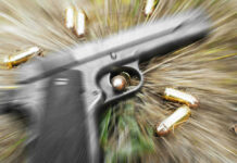Gunfight Erupts: Deputy Marshal Killed Pistol and bullets on grass with motion blur effect.