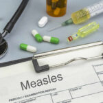 Record Measles Surge — What’s Driving It? Medical supplies including a stethoscope, syringes, and medication related to measles