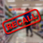 Boston Plant Skips Inspectors — Big Recall Recall stamp on blurred store aisle background.