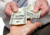 Hidden Cash Mania Explodes Nationwide Two hands exchanging cash bills