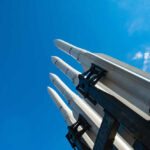 Patriot Crunch Alarms Europe Missile launcher pointing skyward against a bright blue sky