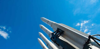 Missile launcher pointing skyward against a bright blue sky