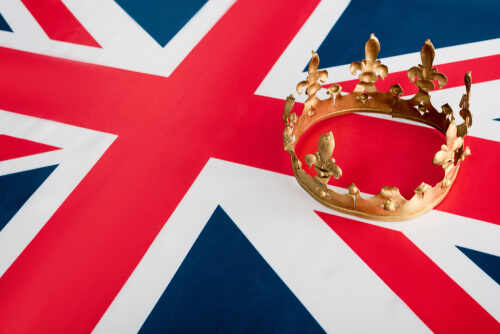 High,Angle,View,Of,Golden,Crown,On,British,Flag A golden crown resting on the Union Jack flag