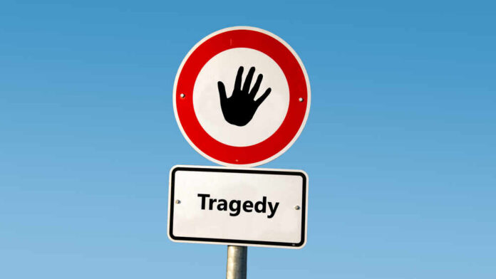 Road sign with hand stop symbol and a lower sign reading Tragedy