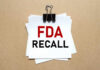 Amazon Food Recall Over Salmonella Scare A notice labeled 'FDA RECALL' clipped to white papers on a brown background