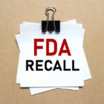 Amazon Food Recall Over Salmonella Scare A notice labeled 'FDA RECALL' clipped to white papers on a brown background