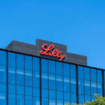 Lilly logo on a modern glass building rooftop
