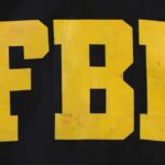 Judge Freezes FBI HQ Flip FBI logo displayed in large yellow letters on a black background
