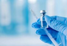Glass Fibers Found In THESE Pet Shots A gloved hand holding a syringe and a vial of liquid