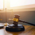 Big Tech on Trial: Parents Blame the Feeds Gavel and scales of justice on desk.