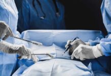 Surgeons performing a procedure in an operating room