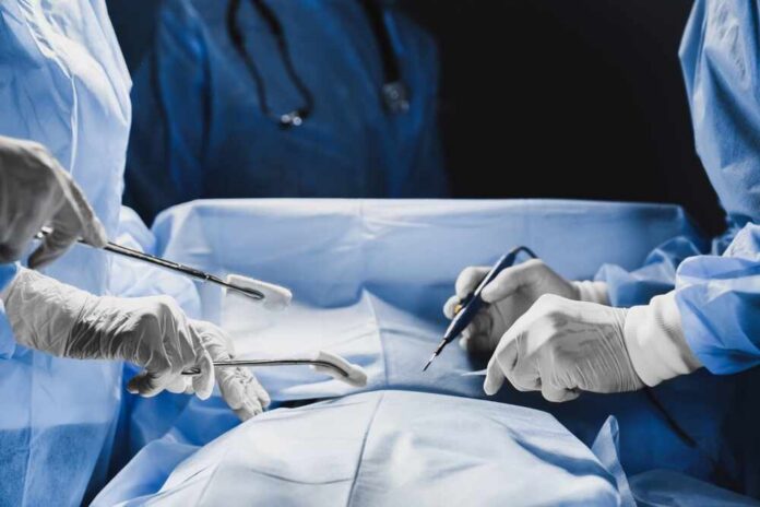 Surgeons performing a procedure in an operating room