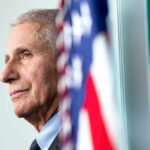 Anthony Fauci close-up with flag.